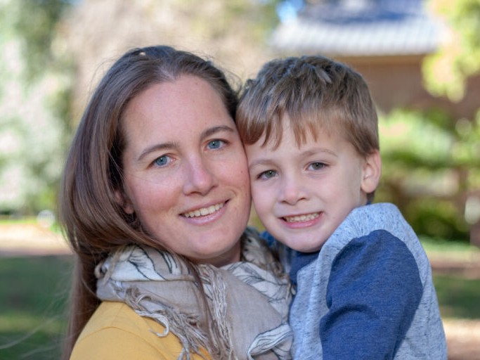 Kim, owner, holds a small child